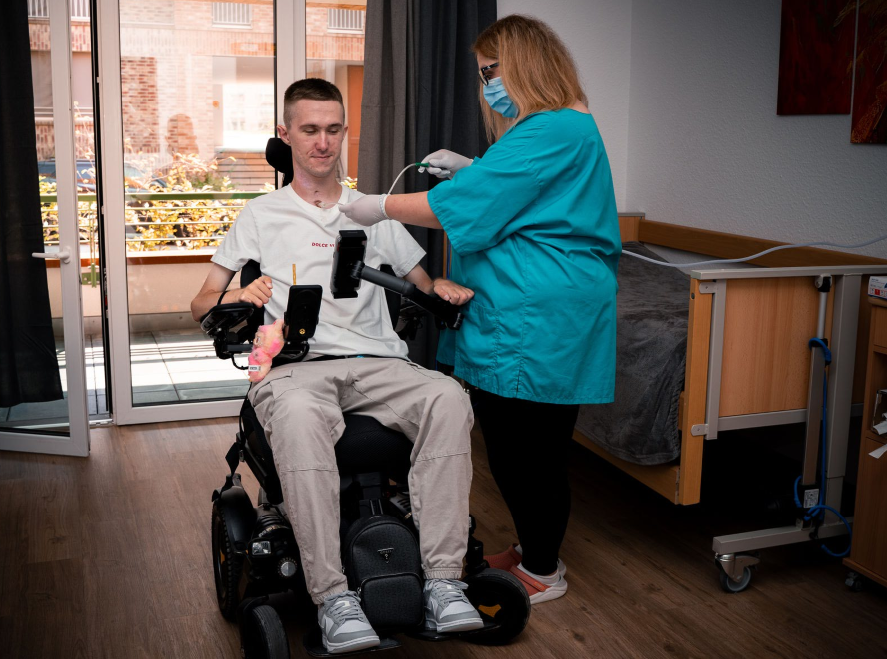 Professional intensive care - Healthcare professional providing care to patient with medical equipment in modern facility